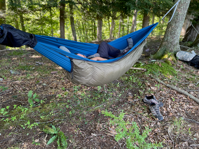 Jacks R Better down hammock underquilt hung beneath a hammock in camp — the warm alternative to a sleeping pad