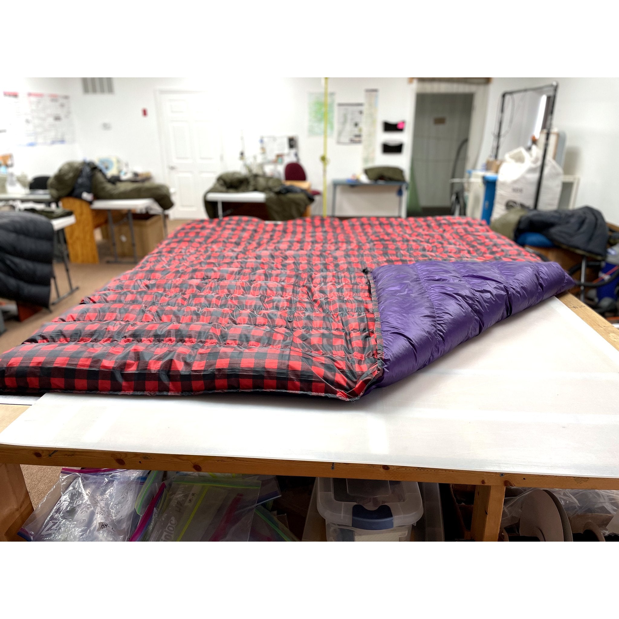 Custom ultralight backpacking quilt in a Buffalo Plaid print, red and black check, with a Purple lining