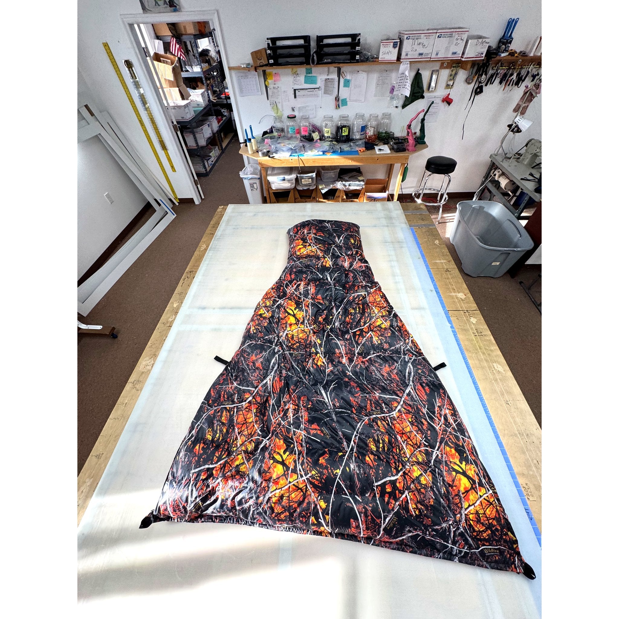 Custom ultralight backpacking quilt in the Lifestyle Camo Wildfire print, black with orange and red flames