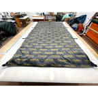 Custom ultralight backpacking quilt in the MAHHA limited edition print, dark grey with yellow lettering