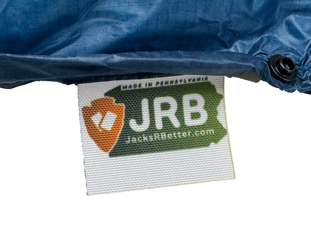 Close-up of the woven Jacks R Better logo tag on the Shenandoah Ultralight 40 degree backpacking quilt